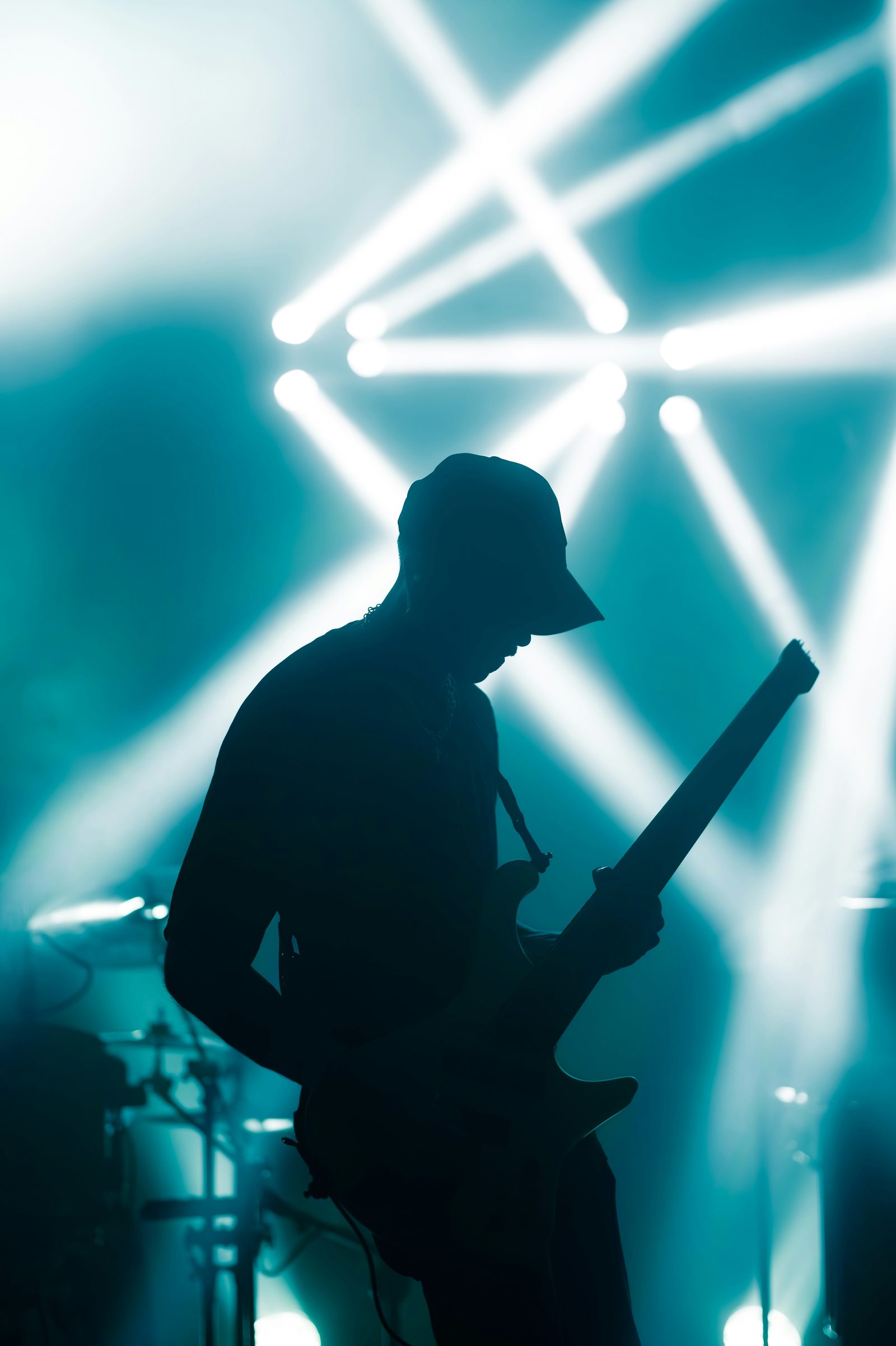 Silhouette of a guitarist performing under stage lights